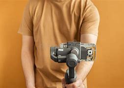 Image result for Man Filming with Smartphone