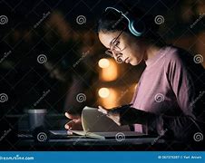 Image result for Image of Woman Studying with Headphones On