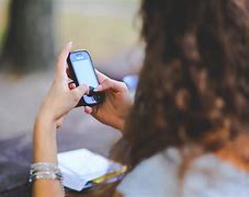 Image result for Images of Someone Holding a Cell Phone