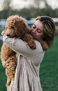 Image result for Lady Cuddling a Puppy