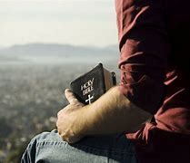 Image result for Picture of a Person Holding a Bible