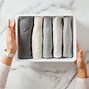 Image result for Clothing Folded On a Table Photo