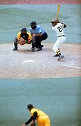 Image result for Roberto Clemente Holding Two Bats