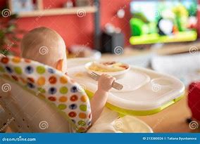 Image result for A Picture of a Baby Watching TV While Eating
