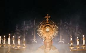 Image result for Priest Holding Up Eucharist