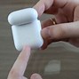 Image result for Air Pods While Charging the Case with Light