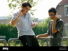 Image result for Boy Speaking On Apple Cell Phone