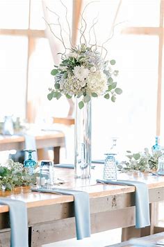 Spring wedding tall floral centerpiece in white and dusty blue | Flower centerpieces wedding, White wedding centerpieces, Hydrangea centerpiece wedding