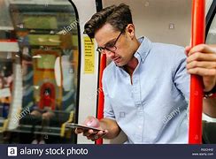 Image result for Free Photo Man On Train Looking at Phone