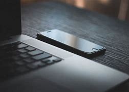 Image result for iPhone and Mac On Black Desk