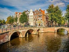 Image result for Twin Copper Spires Plus Canal in Amsterdam Netherlands