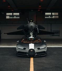 Black and White Bugatti Parked in Front of an Airplane