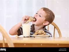 Image result for kid eating cookies and milk