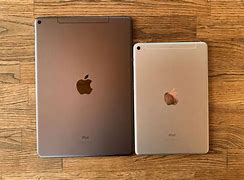 Image result for iPad Mini vs iPhone 14 Pro Size