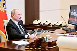 Image result for Putin Sitting Down at Desk