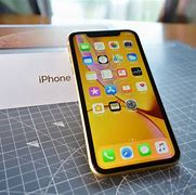 Image result for iPhone XR in Child's Hand