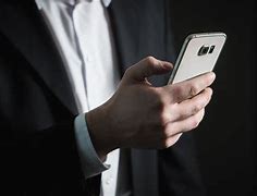 Image result for Man Holding a Smartphone