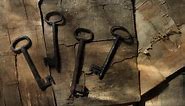 Vintage door keys on weathered wood