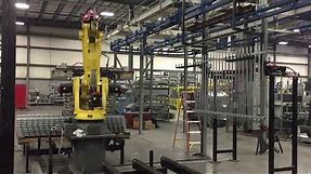 Material Handling Robot Loading a Conveyor Line