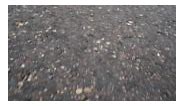 Asphalt pavement sidewalk rough texture background. 4K steadicam shot...