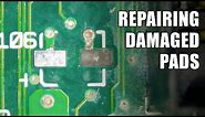 Repairing damaged or lifted pads on a circuit board