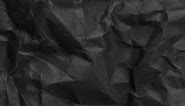 Black grunge crumpled folded stained paper texture