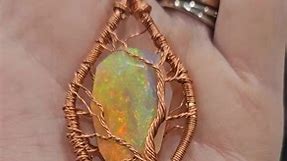 This is the most insanely beautiful opal (from @colorlineimpex). I wear it any time I go anywhere these days. Finishing out 2023 with optimism for 2024. It was a rough year, both personally and for the business. It seemed like a hard(er) year for a lot of people. I hope for you reading this and for everyone, a happy and successful 2024. Happy New Year! #wirewrap #wirewrapping #wirewrappedopal #opal #opaladdict #happynewyear #handmade #wirewrapped #handmadejewelry #wirewrappedpendant #jewelry #wi