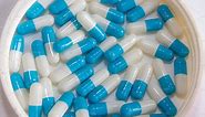 Blue white capsule drug isolated featuring blue, white, and isolated, a Health & Medical Photo by Premium Stock Photo