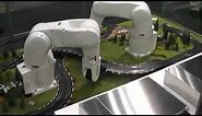 DENSO Robotics - Robots lay out slot-car track