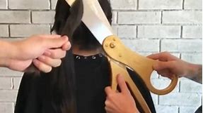 Hairstylist uses giant scissors
