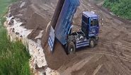 6-Wheel Trucks dumping sand into the water pushing by Dozer 20PG helping trucks.