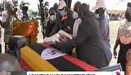 The New Vision - Mourners laying a wreath on the late...