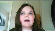 A girl is trying to sing I will always love you by Whitney Houston but keeps failing and gets angry