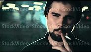 young handsome bearded man smoking cigarette