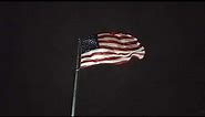 8:24 minute illuminated American Flag waving in the wind at night in 4K UHD
