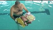 Baby (infant) swimming - floating at 4 week old