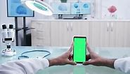 Male Hands Holding a Phone with Green Screen Mockup