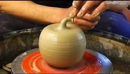 Making / Throwing a ceramic clay pottery Apple on the wheel