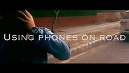 Don't use mobile phones while walking/driving on road (Road Safety).