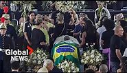 "Greatest person in the world": Pele's coffin carried into Santos soccer stadium for wake