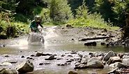 Stock Video Motocross Rider Crosses A River In The Mountain Live Wallpaper