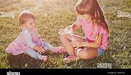 Two little girls are playing on the lawn. Slow motion filmed at 240 fps Stock Video Footage - Alamy