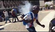 Watch the moment riot police use stun grenades on protesting students