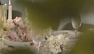 Free stock video - Close up of person pouring champagne into glass at table set for meal at wedding reception 2