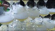 Tower of drinks, a slide of champagne with dry ice and smoke at a party. Glasses of champagne stand