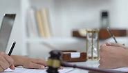 Woman Signing Documents in Court Room, Shaking Hand With Notary Public, Service