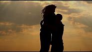 Silhouette of couple in love outdoors. Sunset.