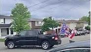 Black truck driving around neighborhood with a Nicki Minaj American flag attached to it