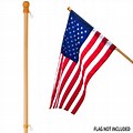 American Flag On Wooden Pole Blue Background