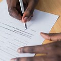 Black Person Signing a Document